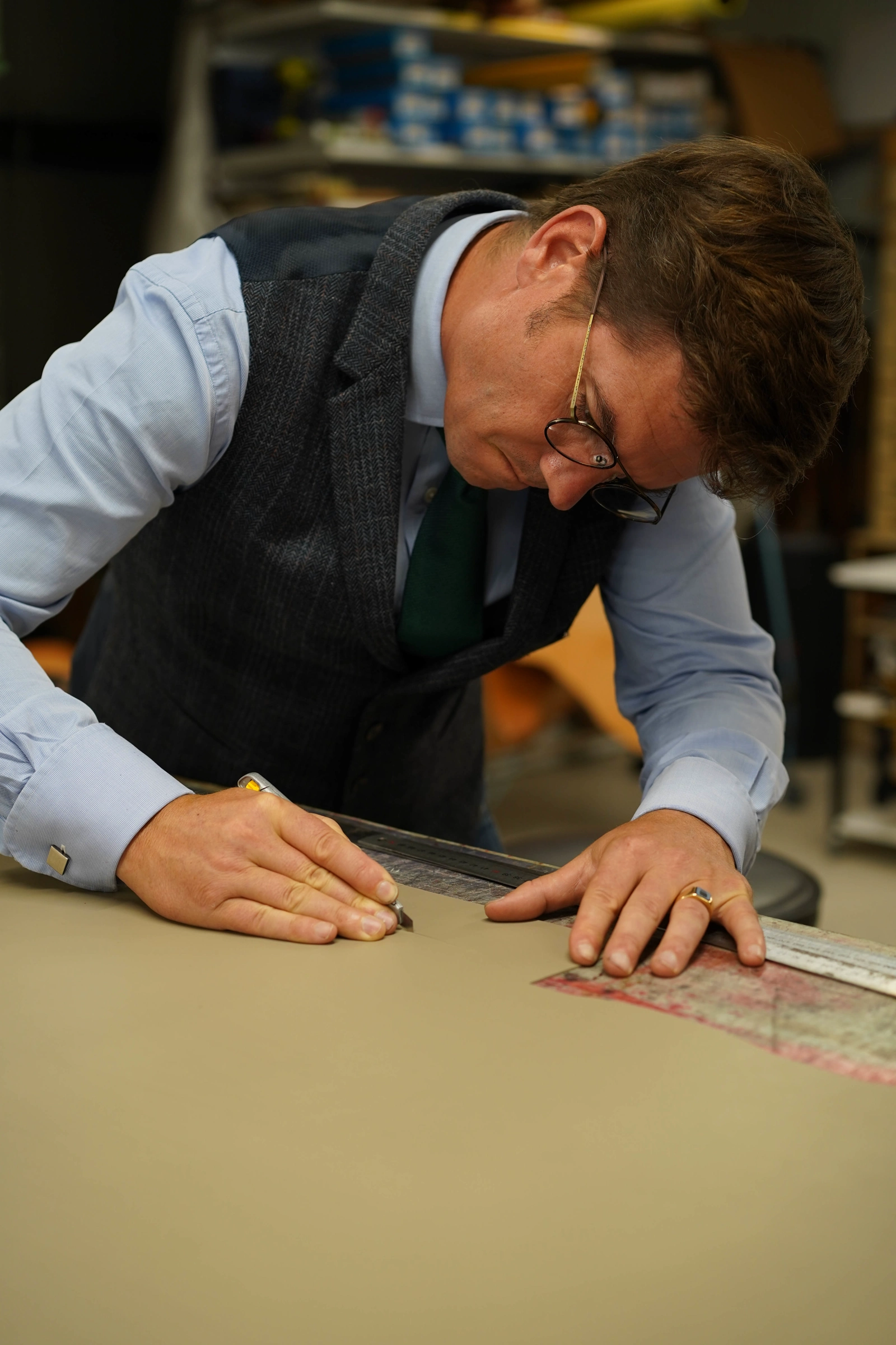 Henry de Freycinet tracing leather at his workbench