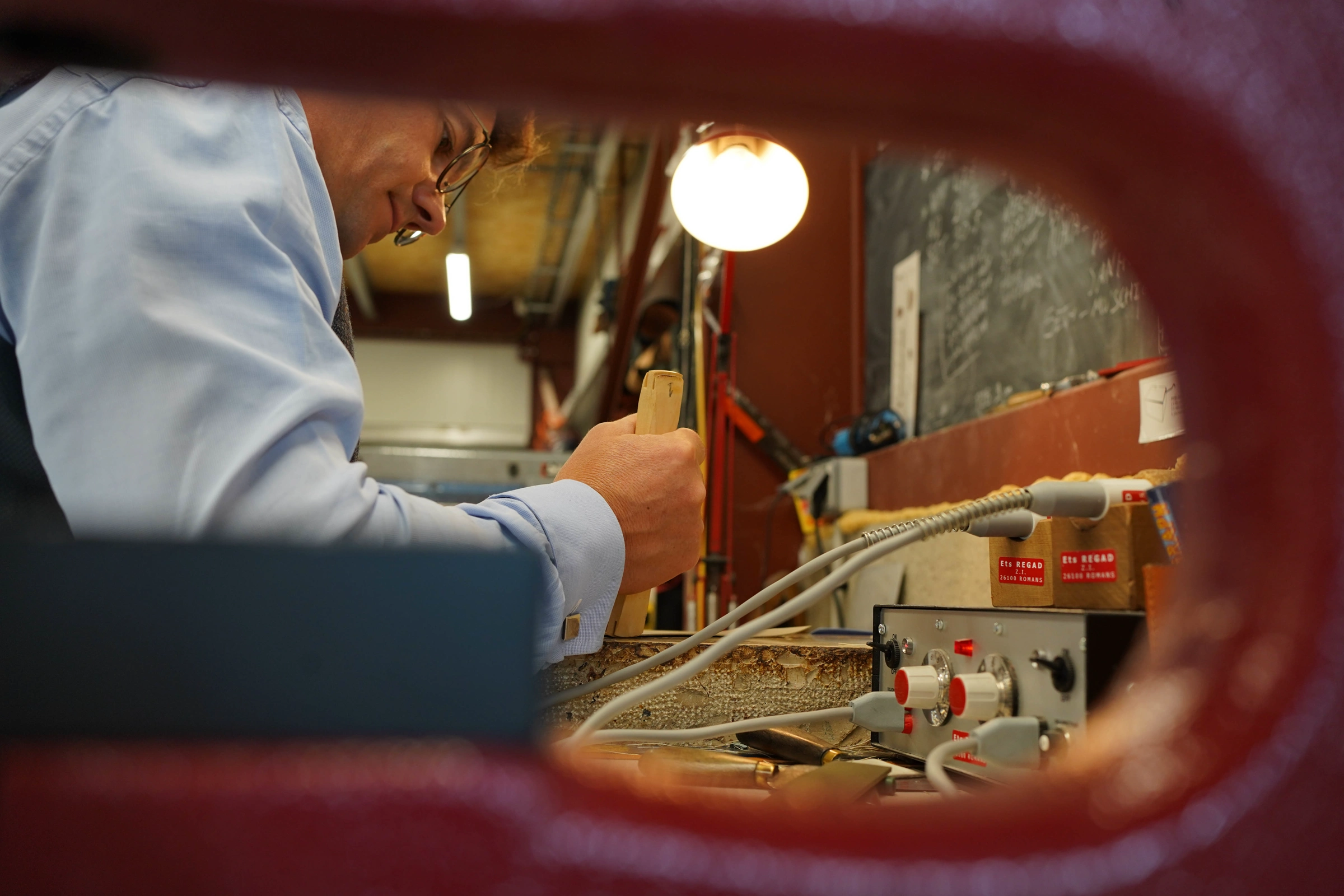 Henry de Freycinet working at a leather press in his workshop