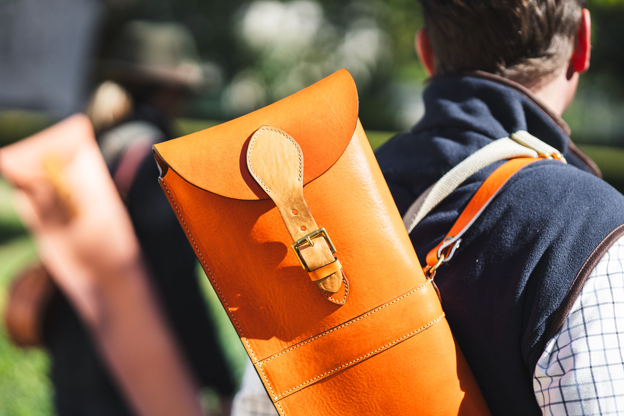 A person wearing a Henry de Freycinet leather shoulder bag